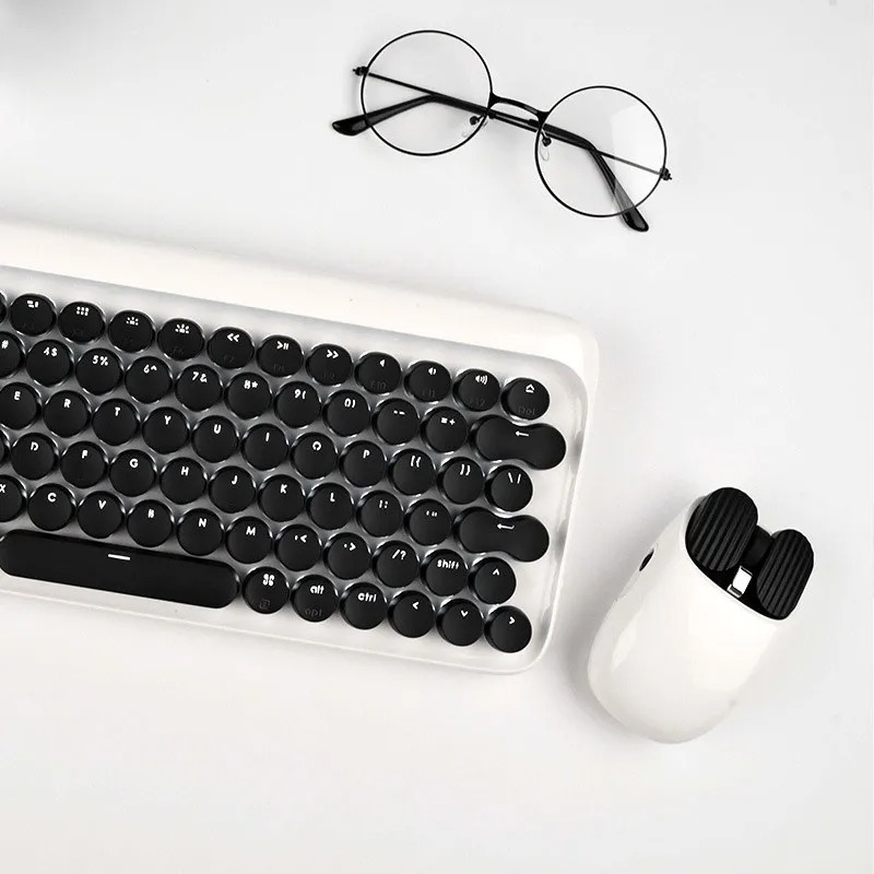 Xiaomi LoFree Duck Dot Wireless Keyboard and Mouse Combo Set: Feature: Introducing the Xiaomi LoFree Duck Dot Wireless Keyboard and Mouse Combo Set, a delightful blend of style and functionality. This combo set is not just a tool for your computing needs; it’s a statement piece that captures attention with its cute and intriguing appearance. The design of this keyboard and mouse combo seamlessly marries the retro elegance of a typewriter with a modern aesthetic. It’s a fusion of the classic and contemporary, making it a perfect fit for any workspace. The exclusive keycap color adds a touch of playfulness to your typing experience, making it more enjoyable and fun. One of the standout features of this combo set is the inclusion of a keyboard pillow. This thoughtful addition provides ergonomic support, reducing wrist strain during prolonged typing sessions. It’s a small but impactful detail that enhances your overall comfort. And let’s not forget about the small yellow duck custom keyboard pad. Printed on both sides, it showcases adorable and cool styles, adding a unique touch to your workspace. Versatility is another strong suit of this combo set. It offers dual connectivity options – wired and Bluetooth – making it compatible with a wide range of operating systems, including Windows, Mac, iOS, and Android. Underneath the keys, you’ll find GATERON green shafts that deliver a responsive typing experience. With full-key, no-punch functionality, you can enjoy faster input speeds, boosting your productivity. To top it all off, the keyboard features a white LED monochrome backlight, adding an elegant and functional touch. It ensures you can work or play in any lighting condition with ease.